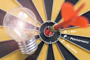 key performance indicator (kpi) with idea bulb lamp and dart successful on bullseye, Smart goals concept for success business