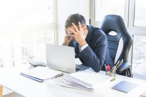 stressed-young-businessman-sitting-workplace